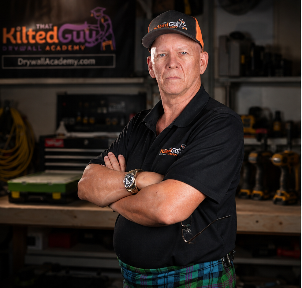 Guy standing in his drywall workshop wearing his kilt